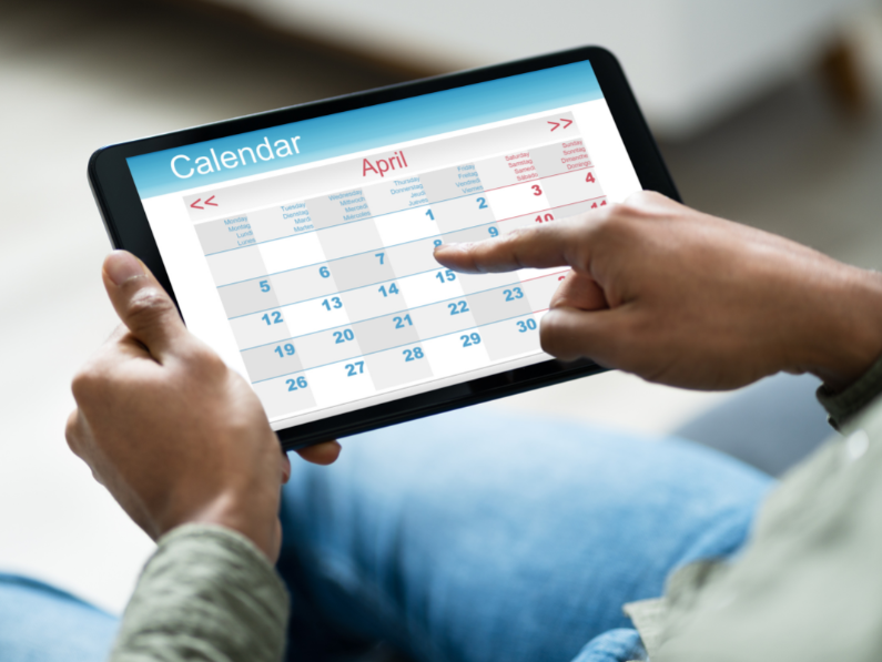 a person on their digital calendar on their tablet preparing to engage in time blocking technique
