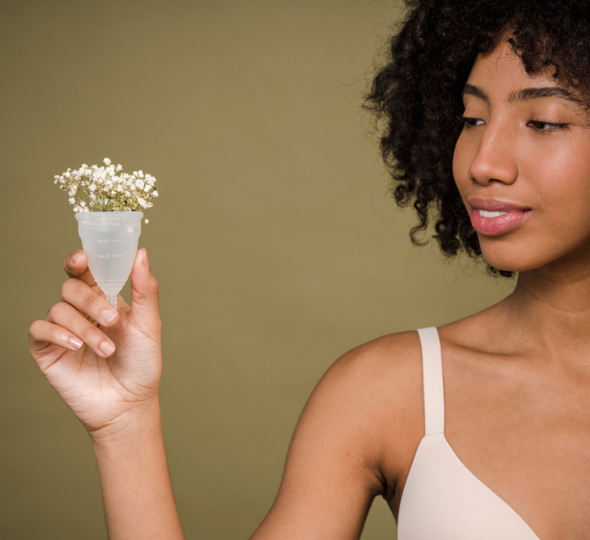 woman holding clear menstrual cup in the battle of menstrual disc versus cup she chose the cup