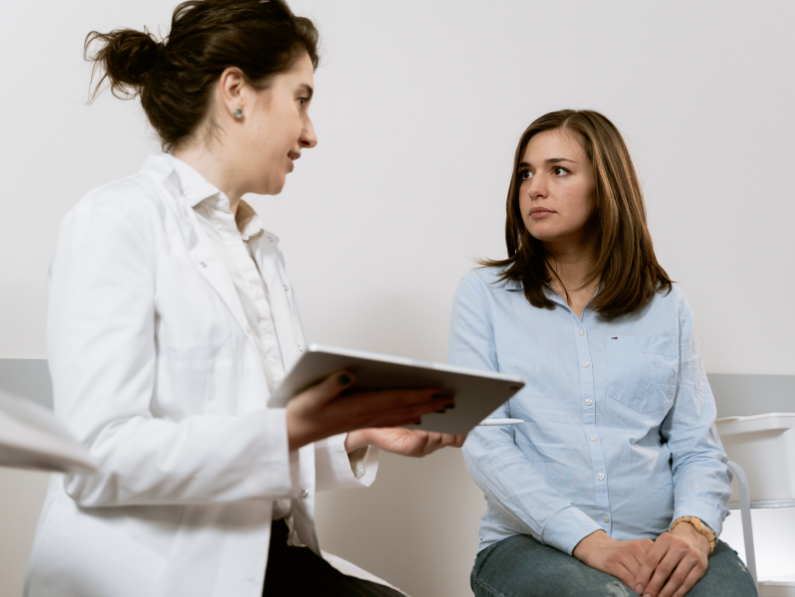 <img src= "doctor talking to patient holding a tablet.png" alt= "doctor explaining period pain to patient using a tablet"/>