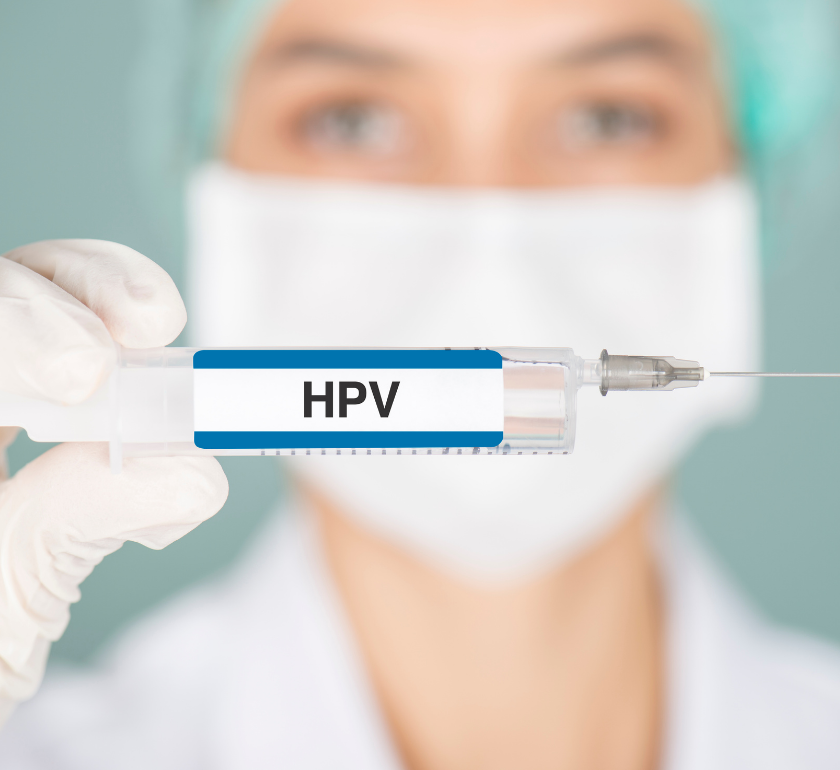female doctor holding needle that says HPV