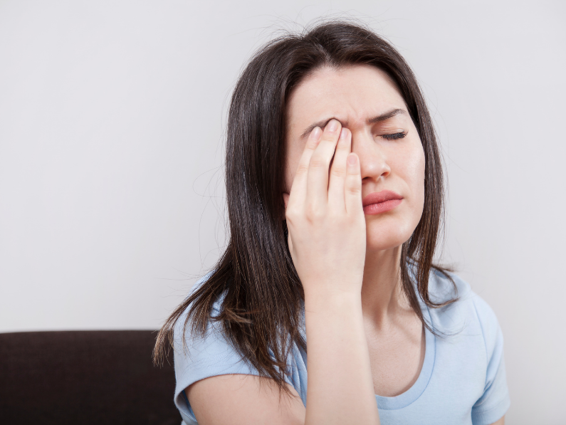 woman rubbing eyes while struggling with managing chronic fatigue