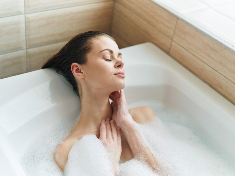 woman taking a relaxing bubble bath to help with stress management