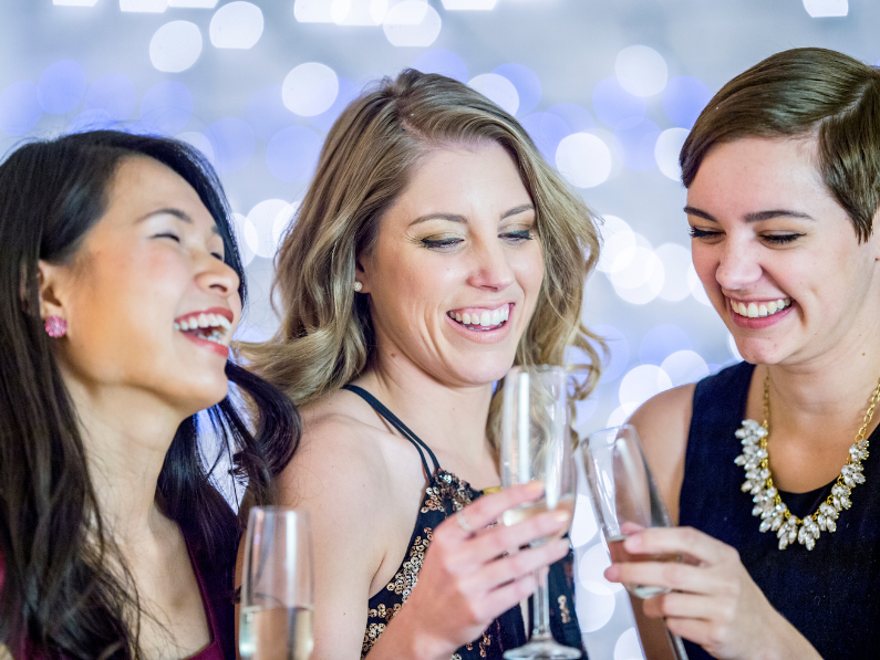 a group of women drinking champagne during the holidays a common bipolar trigger